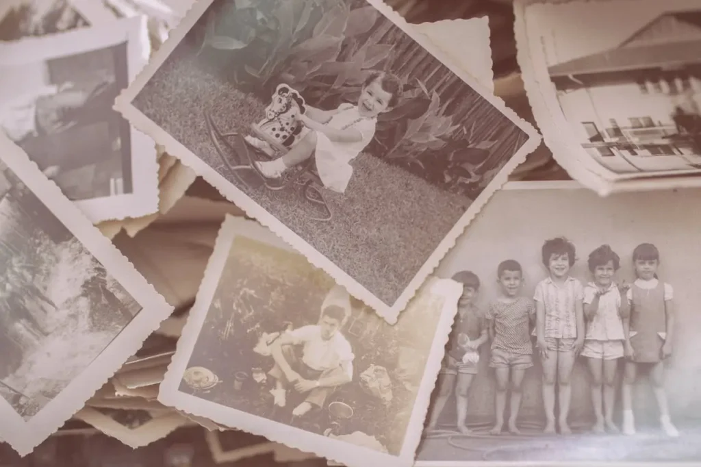 A collection of vintage black-and-white family photographs, featuring smiling children, a girl on a rocking horse, and nostalgic childhood scenes.