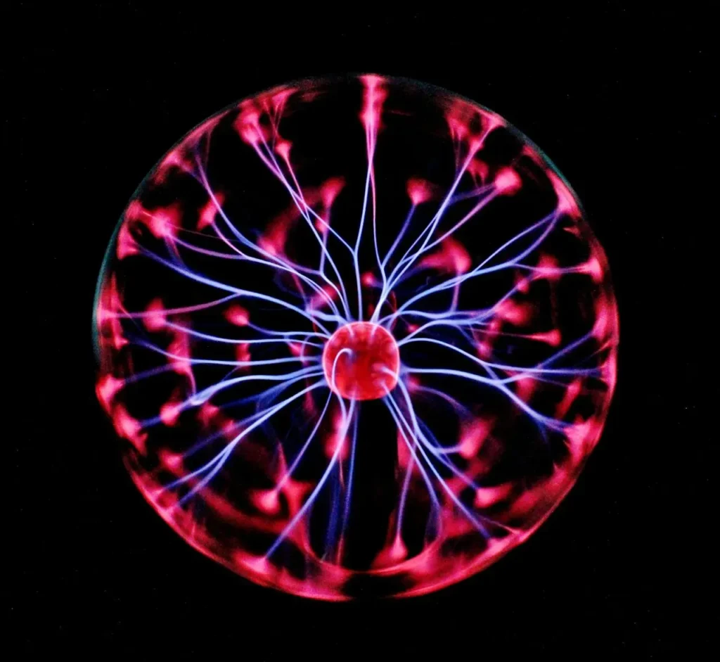 A glowing plasma globe with electric tendrils of blue and red radiating from the center, set against a pitch-black background.